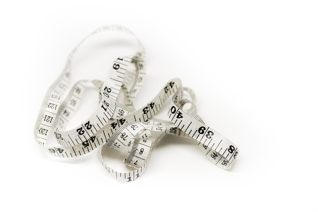 A white flexible measuring tape on a white background