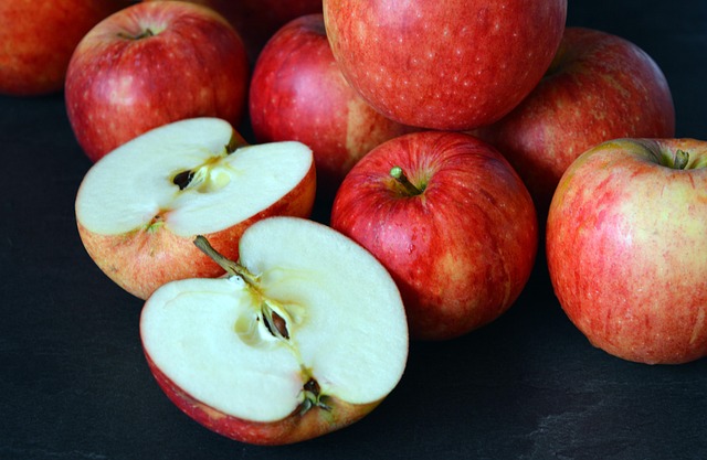 Whole red apples and sliced apples showing cores and seeds