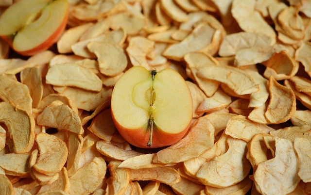 Dried apple slices with half of a fresh apple on top